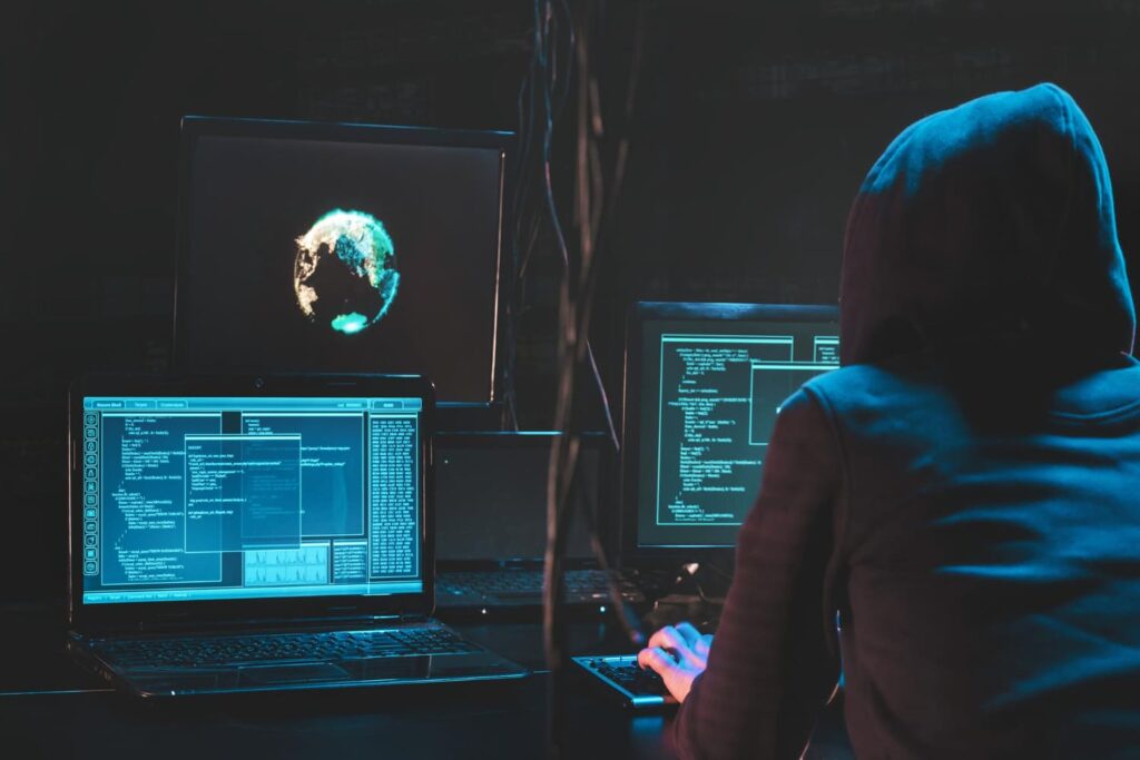 A hacker in front of computer screens